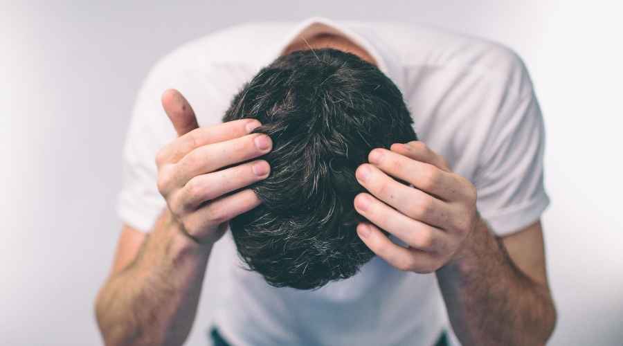 young adult guy checking his hair | PepFactor in Reversing Hair Loss: Success Rates Revealed | Bergen County Hair Loss