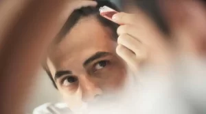 Man applying product to his hair